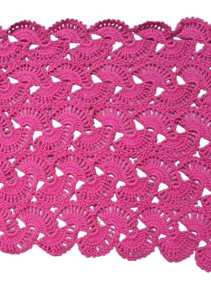The lacy stole in a beautiful magenta pink, showing the scalloped edge detail created by the shell stitch pattern.