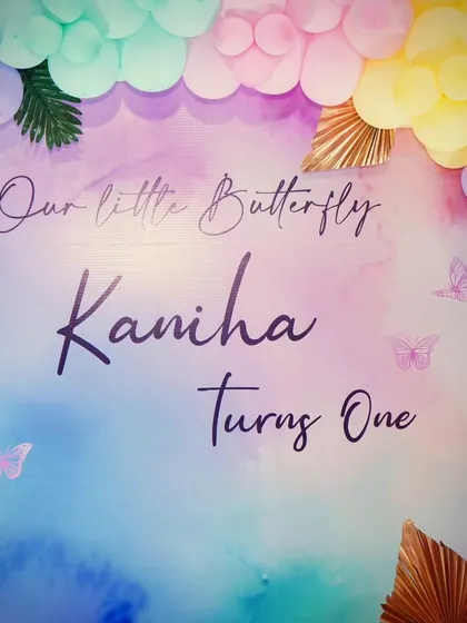A dreamy watercolor-style backdrop for Kaniha's 'Our Little Butterfly' first birthday.