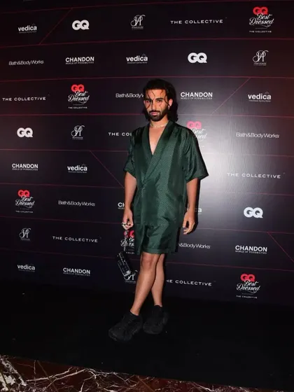 Orry posing on the red carpet at the GQ Best Dressed event. The dark green silk ensemble I styled for him was modern, unique, and perfectly captured his personal style.