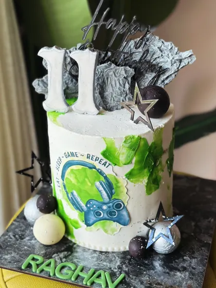 For the ones who find joy in every level. This modern gamer cake features an "Eat-Sleep-Game-Repeat" motif, a controller, and abstract textures for a gamer with taste.