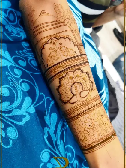 The basic structure of a bridal back-hand design, featuring peacocks, elephants, and floral motifs before the intricate filling is done.