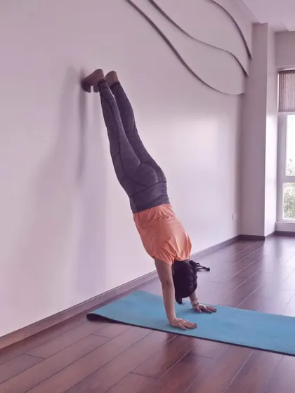 Using the wall to practice handstand kicks. It’s a safe way to build the strength and confidence needed for inversions.