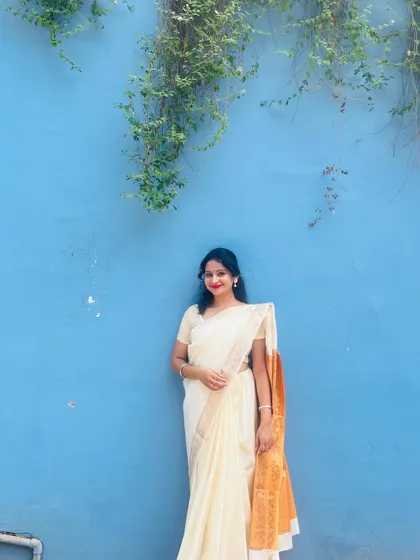 Another photo in my elegant saree against a lovely blue wall. This look is perfect for a sophisticated wedding reception or a classical music evening.