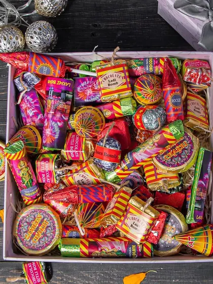 Why burst crackers when you can eat them? Our Diwali Dhamaka Cracker Box is filled with gourmet chocolates shaped like popular firecrackers, in assorted flavours like Rasmalai and Salted Caramel.