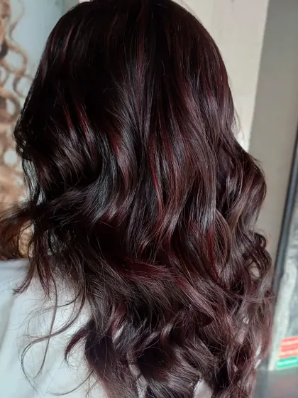 This deep red and violet look is perfect for dark hair. By blending tones from the red family, I created a color that is rich and noticeable without being overly bright, adding depth and interest to the client's hair.