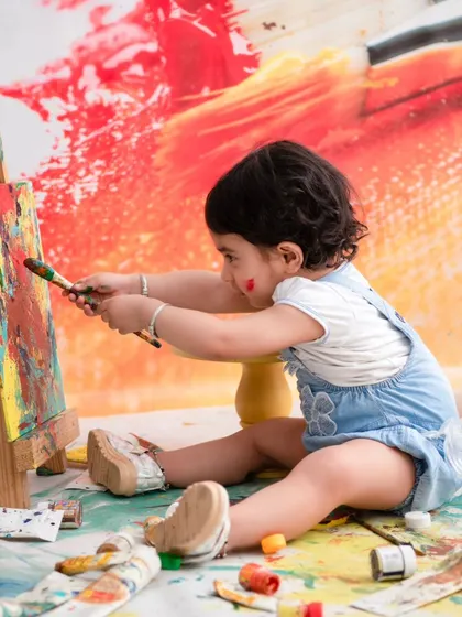 An artist at work. This creative painting session allows children to express themselves and get a little messy, resulting in authentic and joyful photos.