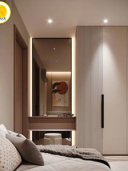 A bedroom design featuring a built-in dressing table with a backlit mirror, seamlessly integrated next to a fluted wardrobe panel.