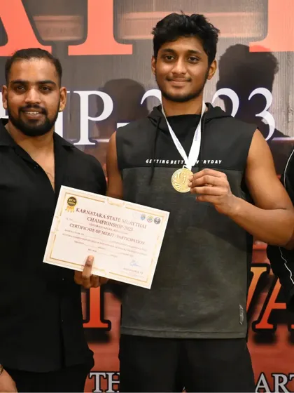 Our fighter proudly displaying his gold medal and certificate from the Karnataka State Muay Thai Championship.