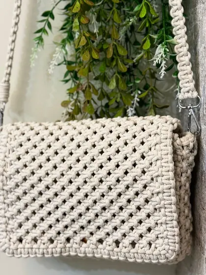 A simple yet beautiful off-white sling bag. This is a great neutral piece that will match any outfit.