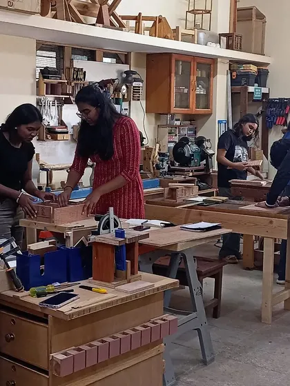 The workshop buzzing with activity as design students work on their projects. It's a day of intense learning, creativity, and sawdust.