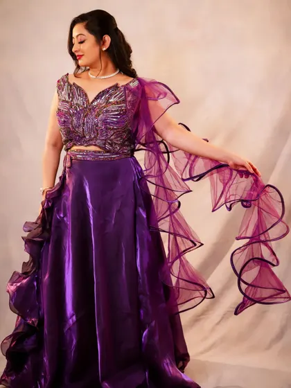 Another angle of the purple lehenga, capturing a moment of movement. This kind of shot is great for showing the life and energy of an outfit.