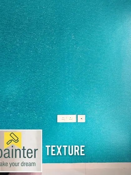 A vibrant aqua-colored wall with a subtle, sand-like texture. This finish adds both color and tactile dimension to a room.