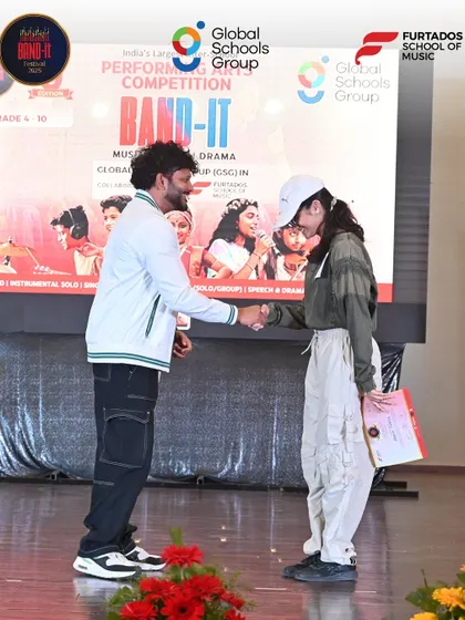 A handshake celebrating a great performance. A participant receives her certificate at the Bangalore event.