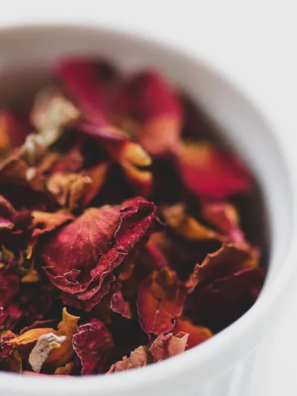 Dried rose petals in a bowl. We teach our students about this exotic ingredient's role in frontier cuisines, from garam masalas to biryanis.