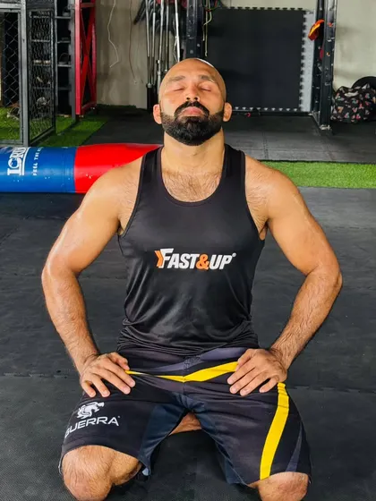 A moment of meditation and focus after a hard training session. The fight is as much mental as it is physical.