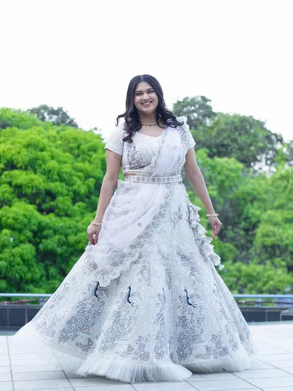 Preeti looking absolutely radiant for her engagement. The elegant white lehenga is paired with a soft glam makeup look that is both modern and timeless.
