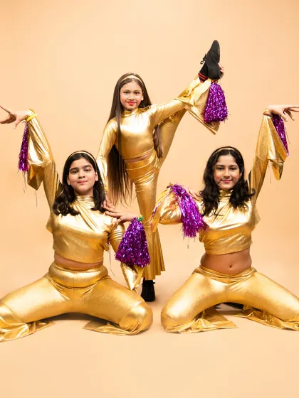 A dynamic pose from our disco fever routine. This performance showcases the flexibility and coordination our young students develop in their jazz classes.