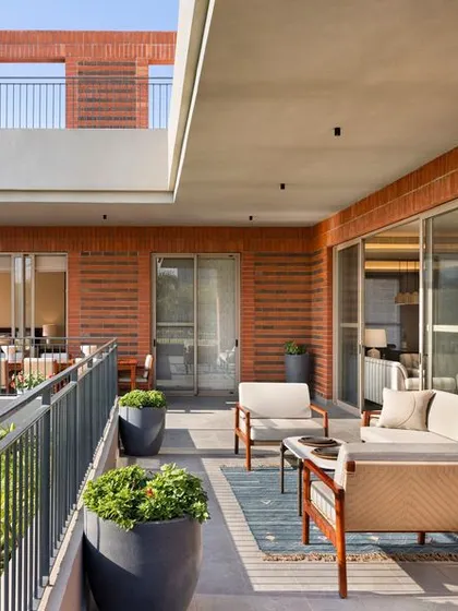 The beautiful brick-clad exterior and spacious deck of the Max128 apartment.