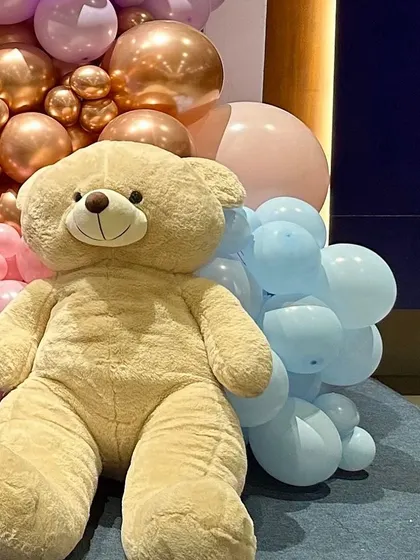 A close-up of the large teddy bear prop I used for the "We Can Bearly Wait" baby shower. These props add a cute and cuddly element to the decoration and are great for photos.