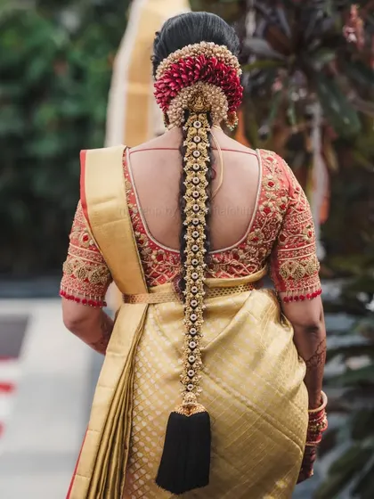 This is a quintessential South Indian muhurtham look. I created a flawless base with a bold red lip for Supritha, which stands out beautifully against her golden silk saree and traditional jewellery. The detailed bridal braid completes this timeless look.
