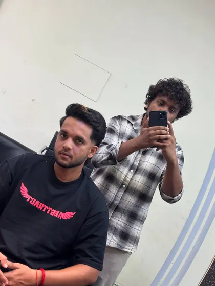 A fresh look for cricketer Harsh Dubey. This style features a clean fade and some texture on top.