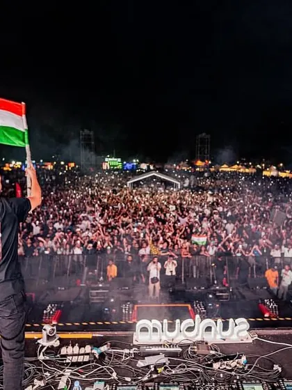 Like Mike holds the Indian flag high, looking out over a massive crowd of fans at their Bengaluru show.