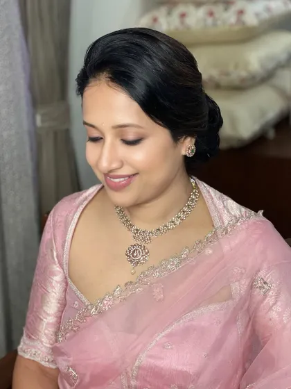 Pastel hues and timeless views. This client's look is all about soft, glowing skin and a gentle touch of colour, perfectly matching her delicate pink organza saree and diamond jewellery.