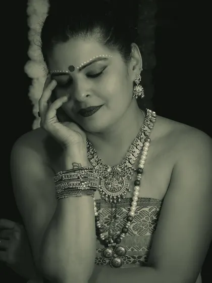 A monochrome version of the Onam fusion look, highlighting the textures of the jewelry and the traditional bindi art.