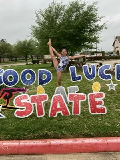 Our Level 8 gymnast, Camila, shows off her amazing flexibility while wishing her luck at the State Championships.
