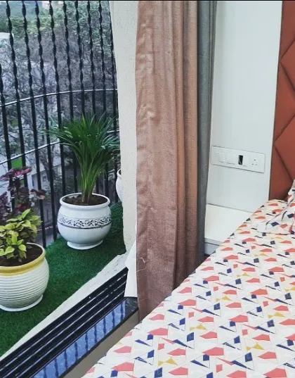 This design brings the outdoors in by placing the bed right next to a balcony garden. The custom quilted headboard adds a touch of luxury, creating a resort-like experience for the homeowner every day.