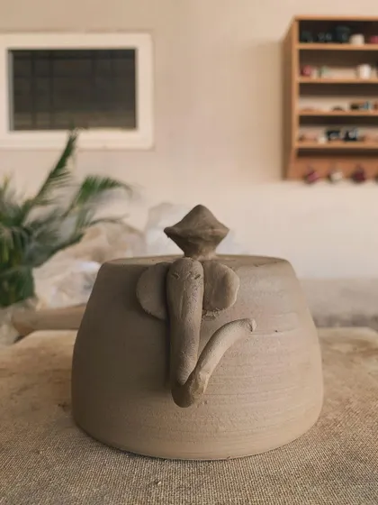 A raw, unglazed elephant pot, waiting for the kiln. The little details, like the shape of the ears and the curve of the trunk, give it so much personality.