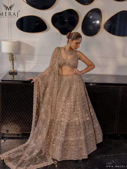 A full view of the beige lehenga, showcasing its delicate zardosi work, shimmering sequins, and soft thread detailing.