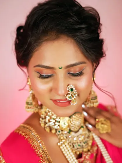 Another beautiful close-up of the bride, highlighting her delicate features and the intricate details of her nath (nose ring) and jewelry.