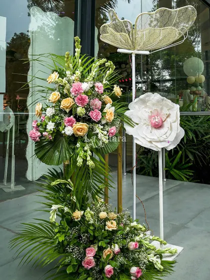 A beautiful floral arrangement with a delicate, oversized butterfly prop. These arrangements were placed at key points, like the entrance, to tie the entire decor theme together.