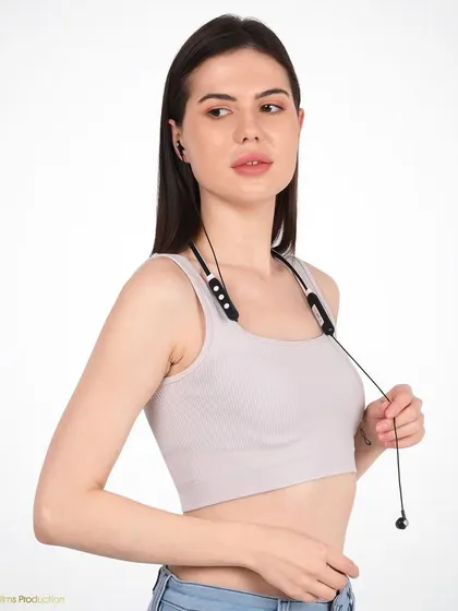 A lifestyle shot of a model wearing a neckband. This demonstrates the product in a real-world context, showing how it rests comfortably and stylishly on the user.