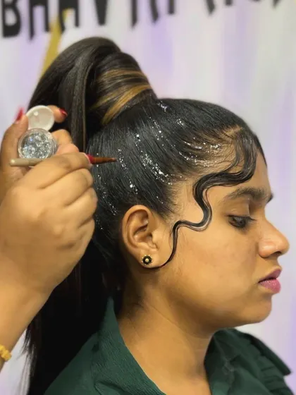 Adding the final touch of glitter to the sleek ponytail. This detail elevates the hairstyle from simple to show-stopping.