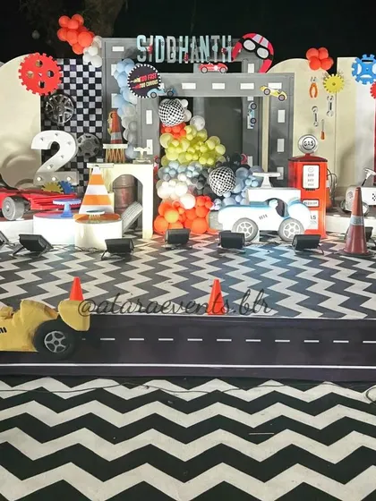 A wide view of the impressive race car stage, complete with a custom road-printed floor mat and multiple car props, creating a complete racing world.