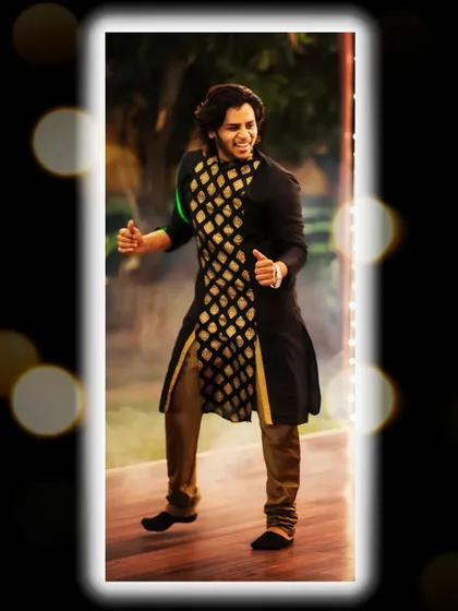 A professional shot of me in a black and gold kurta, captured mid-performance during a wedding event. I love bringing my energy directly to the stage.