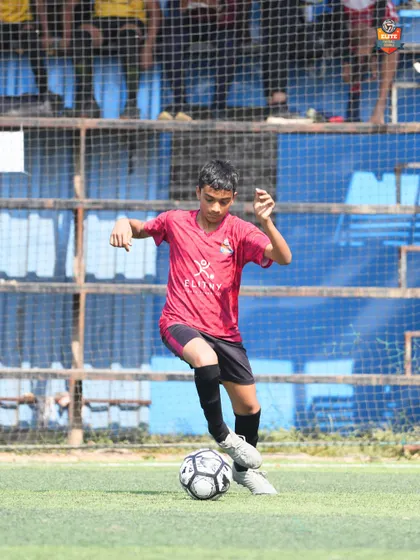 A young player showing great ball control under pressure during a crucial Leno Premier League match.