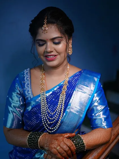 A beautiful portrait of a bride in a royal blue Kanjeevaram saree. I designed a simple, matching blouse to let the saree's richness shine.