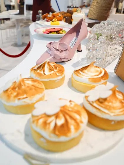 Lemon meringue tarts sit alongside a classic Jimmy Choo heel. At our brand activations, we love creating these visual dialogues between the fashion items and our culinary creations.