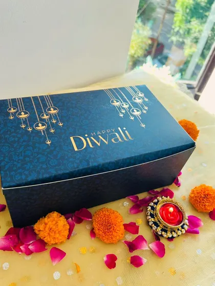 The elegant navy blue and gold box I use for the 'Khushiyon Ki Diwali' hamper, set against a festive backdrop.
