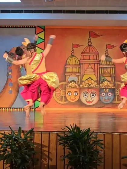 Two students captured in a mid-air jump, a challenging move they have mastered through dedicated practice.
