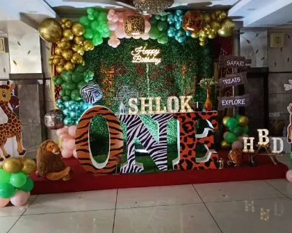 Shlok's first birthday safari was a hit with this jungle theme. We used large animal print "ONE" letters, a greenery backdrop with a neon sign, and plenty of animal props to explore.