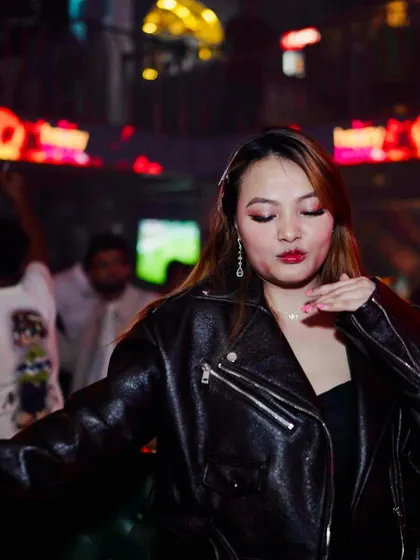 A guest in a leather jacket looking cool and confident, enjoying the new Tuesday night vibe.