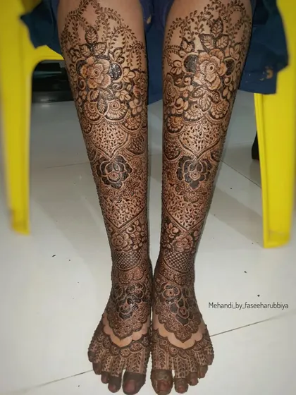 This angle shows the beautiful symmetry and coverage of the bridal leg henna design.