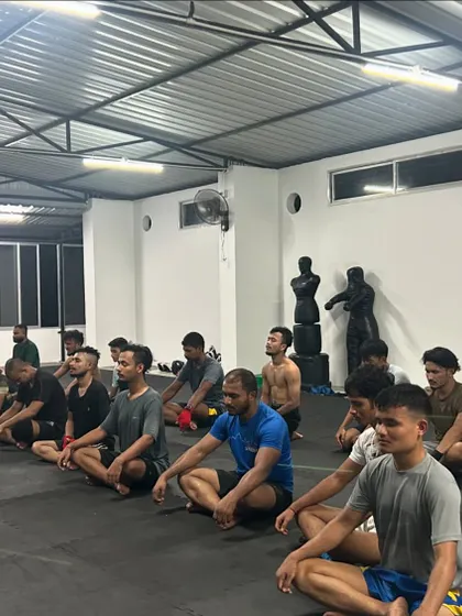 A moment of calm and focus. The team meditates together after a tough seminar. We train the mind just as much as the body.