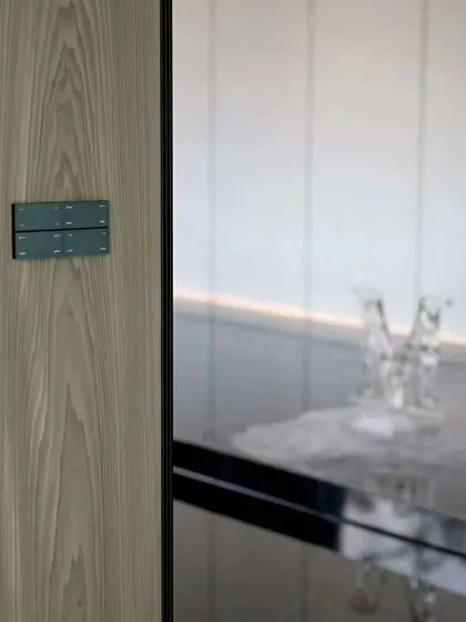 A Moorgen smart panel from the Swiss Series, seamlessly integrated into a wood-paneled wall. Its minimalist design ensures that your home's aesthetic remains clean and uncluttered while providing full smart control.