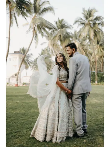 A lovely portrait from their engagement day, surrounded by palm trees. The way they look at each other shows their deep love and happiness.