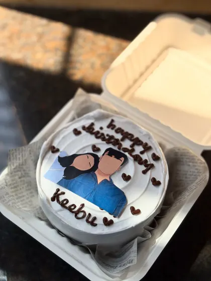 A personalized bento cake featuring a custom faceless illustration of a couple. This is a wonderful way to add a personal touch to a birthday or anniversary cake.